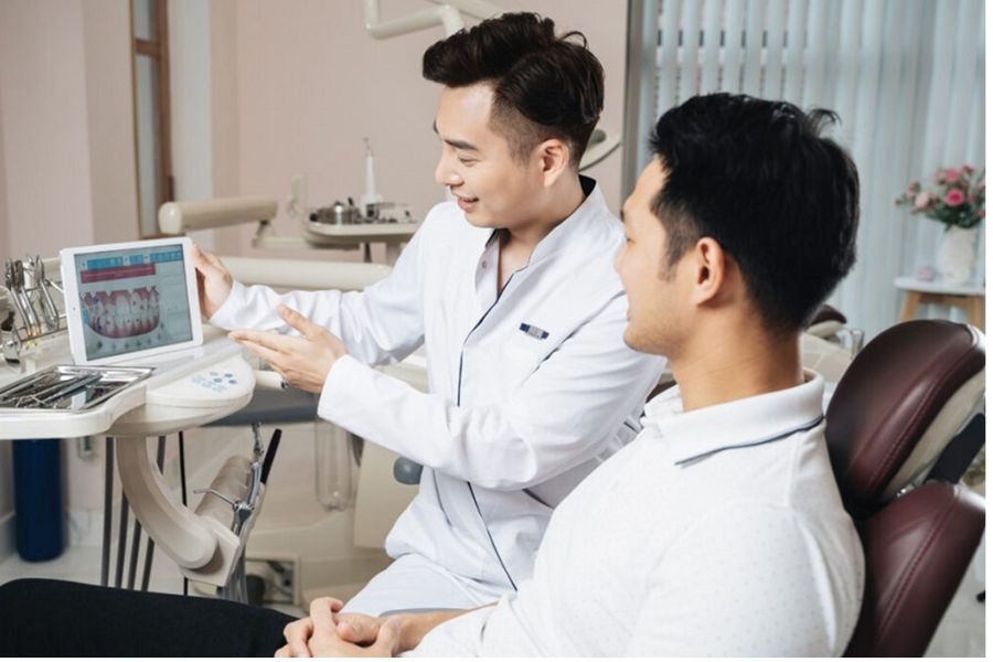 Bác sĩ nha khoa đang tư vấn cho bệnh nhân về phương pháp điều trị cười hở lợi